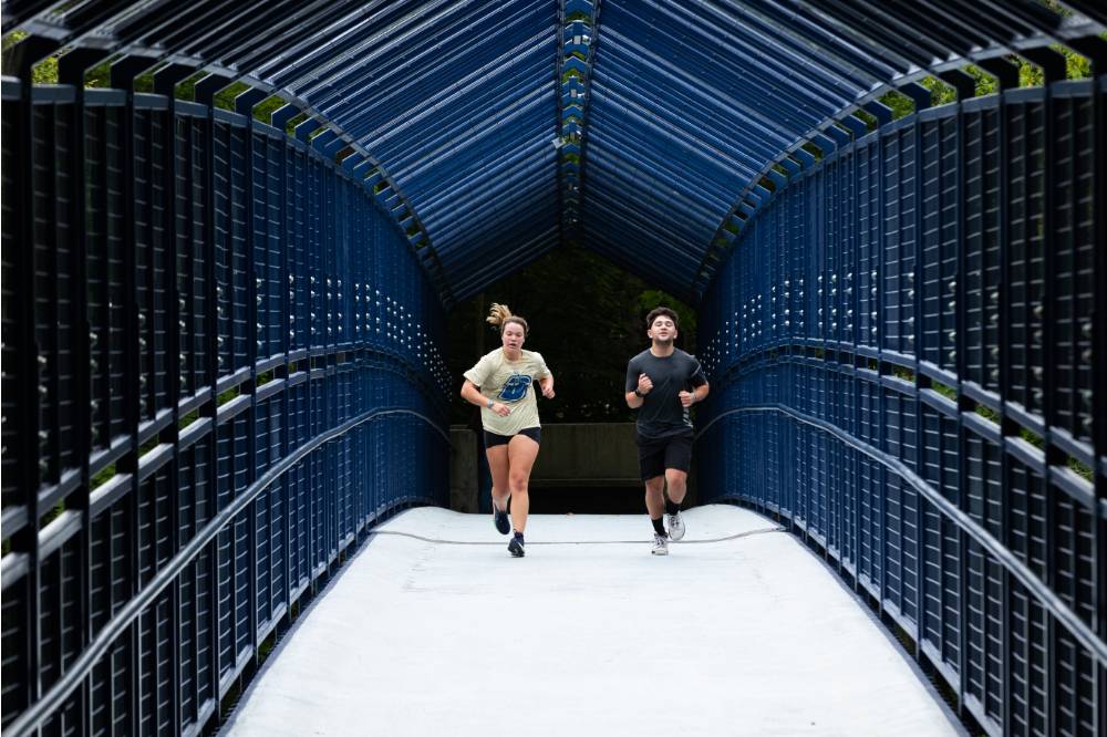 A couple runs together through little mac bridge